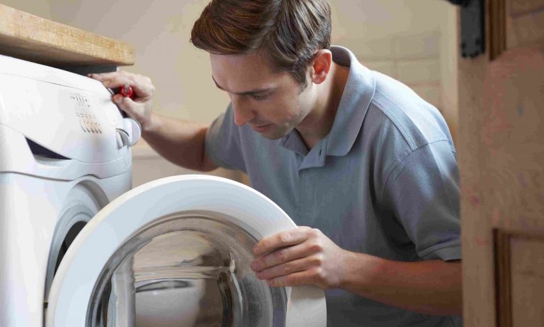 engineer mending domestic washing machine 163881483 5ab72215c064710036468012