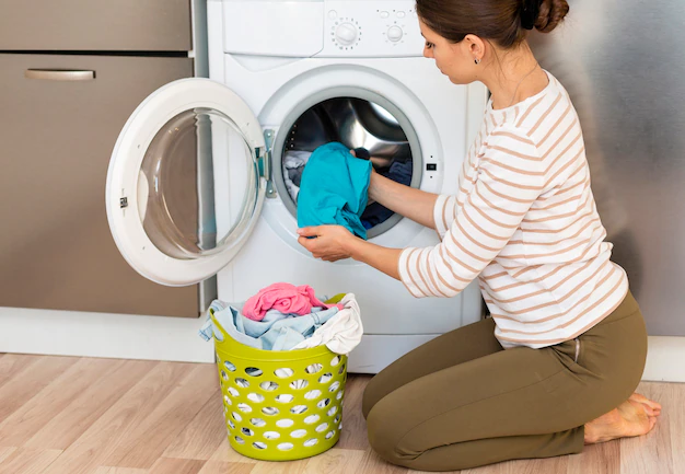 woman taking clothes out washing machine 23 2148386943 1