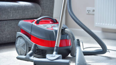 canister vacuum cleaner for home use on the floor
