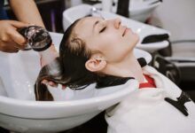 happy young woman with hairdresser washing head hair salon 110645 79