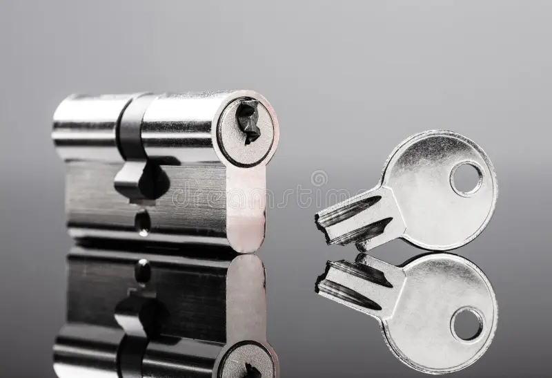 pin tumbler cylinder lock broken key close up reflective desk 210608673