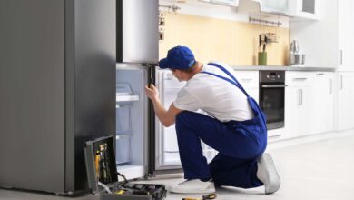homeguide repair technician fixing a refrigerator and freezer