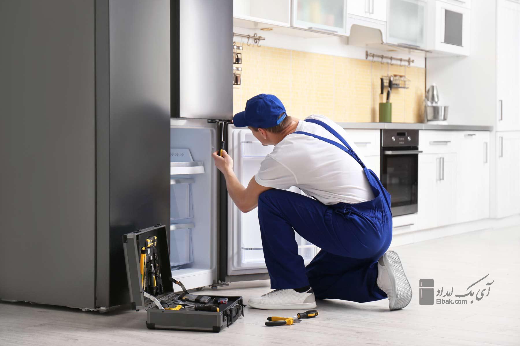 homeguide repair technician fixing a refrigerator and freezer 1
